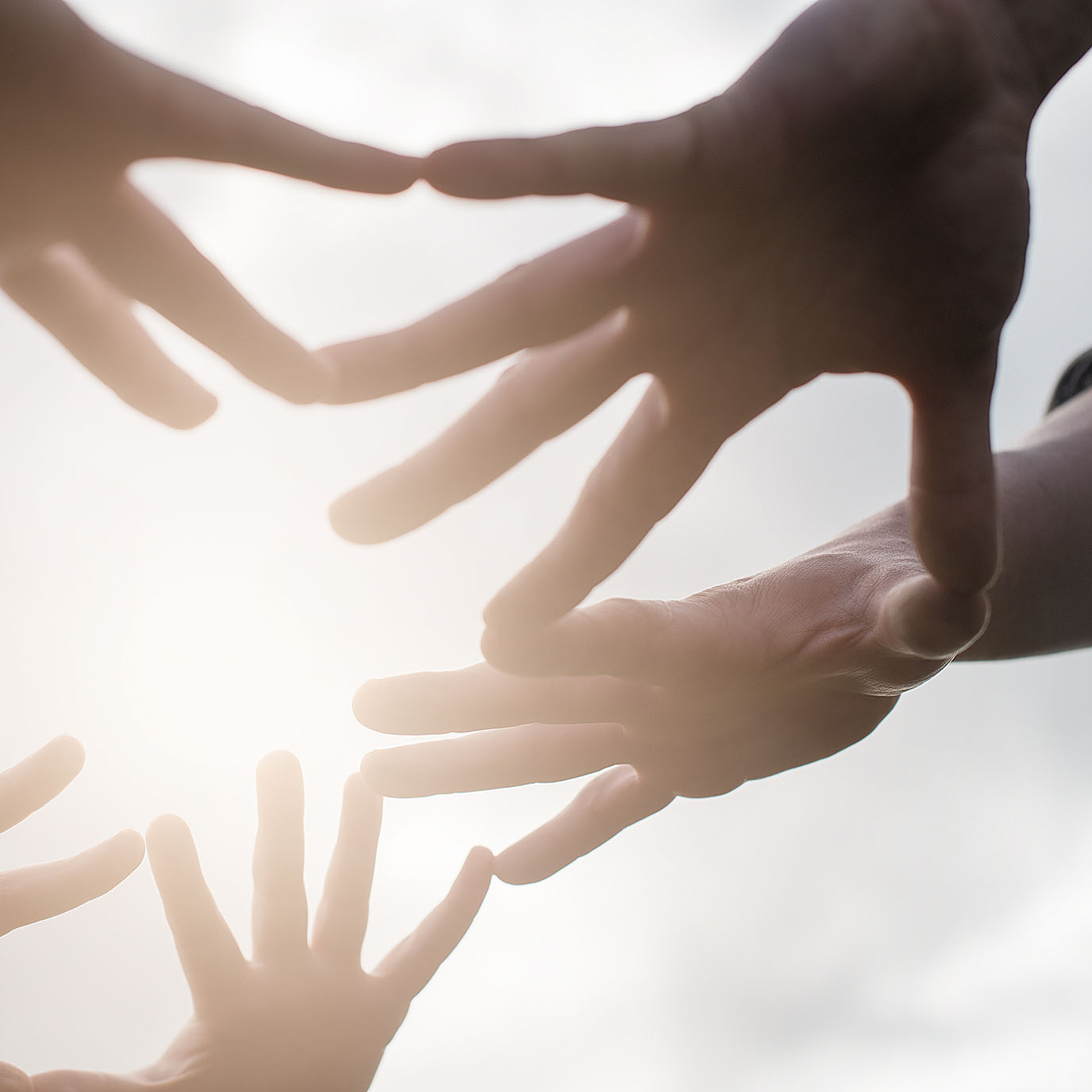 Hands reaching out in support of traumatic brain injury survivors